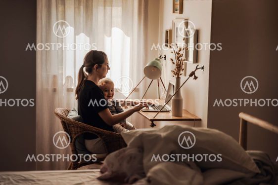 Woman working at home with her baby