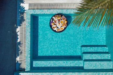 A floating breakfast tray with various dishes and drinks...