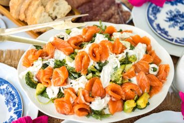 A fresh tasty salmon salad is served with avocado and...