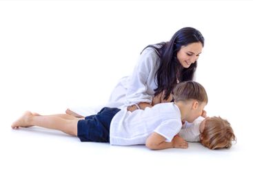 Young mother and her two little boys. Woman in casual...
