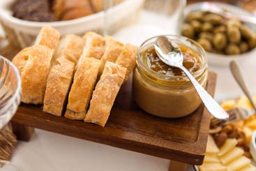 A close-up of a wooden tray with slices of fragrant...