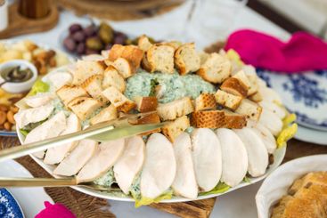 Caesar salad with delicious chicken rests on a white...