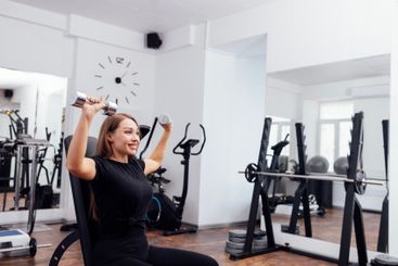 Athletic young blondy woman in black sportswear is doing...