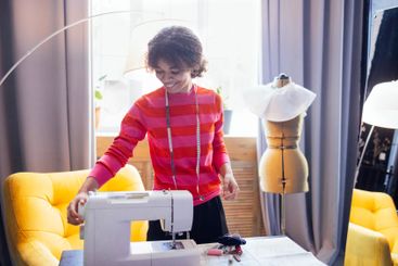 Young African woman in casual clothing works with...