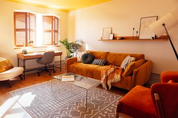 Modern living room with wooden furniture. Bright sunlight