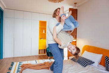 An elderly woman and her granddaughter are having fun on...