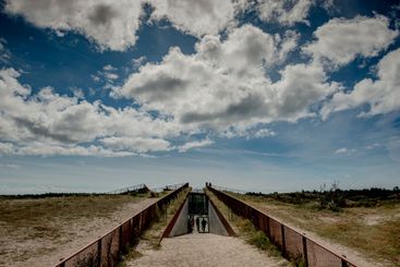 Clouds above beach walkway