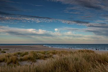 Clouds over grass on sand dunes