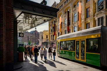 Pedestrians and tram on city street in Helsinki, Finland