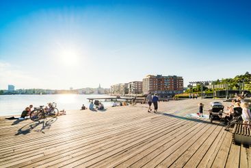 People on boardwalk at sunset in Stockholm, Sweden
