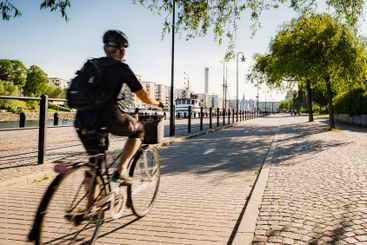 Cyclist by waterfront in Stockholm, Sweden