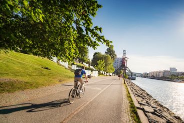 Cyclist by waterfront in Stockholm, Sweden