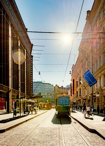 Tram on city street at sunset in Helsinki, Finland
