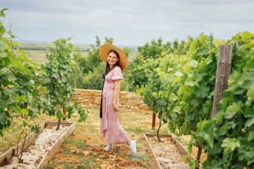 Attractive smiling girl in elegant pink dress walks...