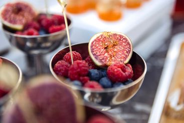 A polished silver bowl is filled with a variety of fresh...