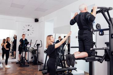 Elderly couple of people in ems suits are engaged in...