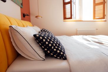 Close-up of contrasting pillow cases on a cozy large bed...