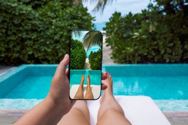 The girl holds the phone and takes pictures of her legs...