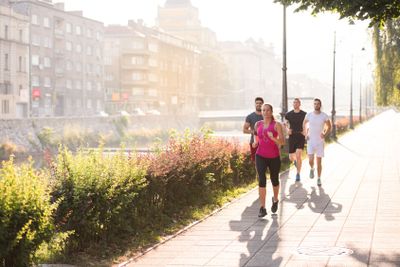 group of young people jogging in the city