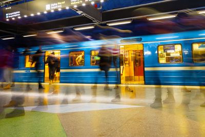 Stressed motion blurred people walking on and off the...