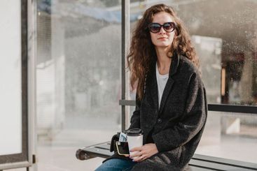woman sitting waiting bus station
