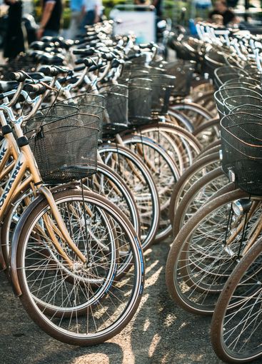 Row of city parked bicycles bikes for rent on sidewalk...
