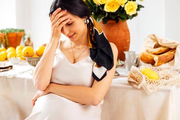 A young woman is sitting in profile and waiting for...