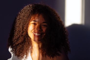 Close-up portrait of a young laughing African woman...