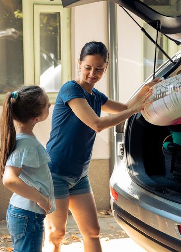 Mother and little girl going to seaside