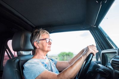 senior caucasian woman drive the car from inside point...
