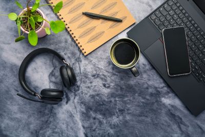 Working from home. Desk office with laptop, notepad,...