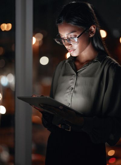 Night, work or woman reading on tablet for research,...