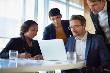 Employee, people and laptop in office on meeting for...