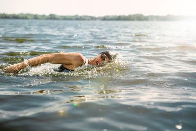 Professional triathlete swimming in river's open water