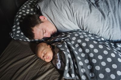 Newborn Baby boy sleep with his father