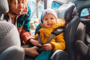 Portrait of smiling caucasian mother prepares her little...