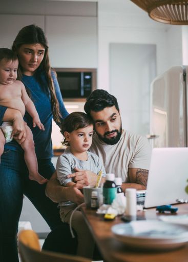 Family consulting online on video call through laptop in...