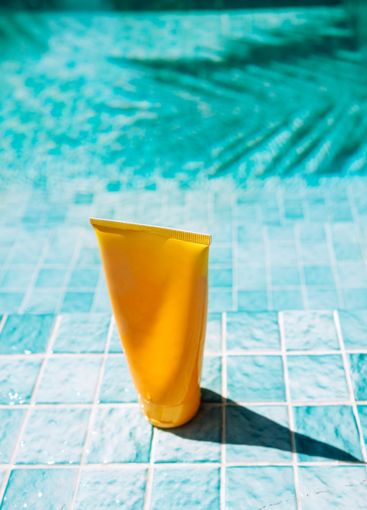 A mock-up of a yellow tube for sunscreen. Cosmetic...